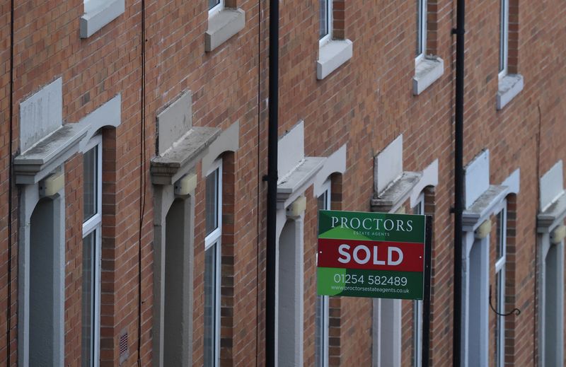 FILE PHOTO: An estate agent's board is displayed outside a house on a terraced street in Blackburn