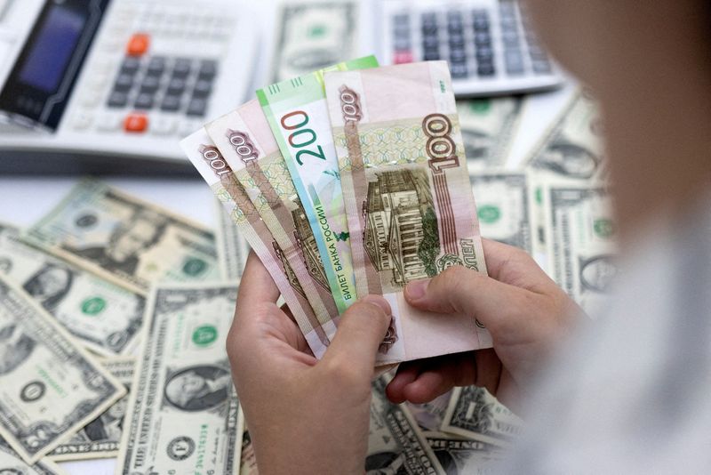 FILE PHOTO: Illustration shows Russian Rouble and U.S. Dollar banknotes