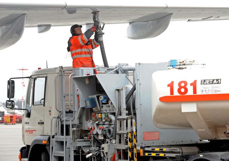 FILE PHOTO: A worker fills an Airbus jet with aviation fuel at Fuhlsbuettel airport in Hamburg