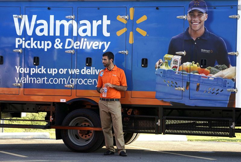 FILE PHOTO: A Wal-Mart Pickup-Grocery employee waits next to a truck at a test store in Bentonville