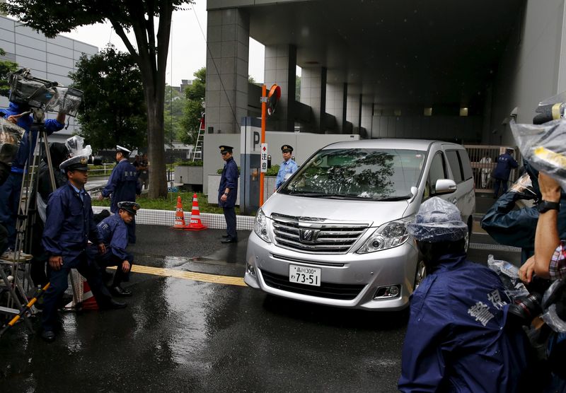 FILE PHOTO: A car carrying former Toyota Motor Corp executive Hamp leaves Harajuku Police Station in Tokyo
