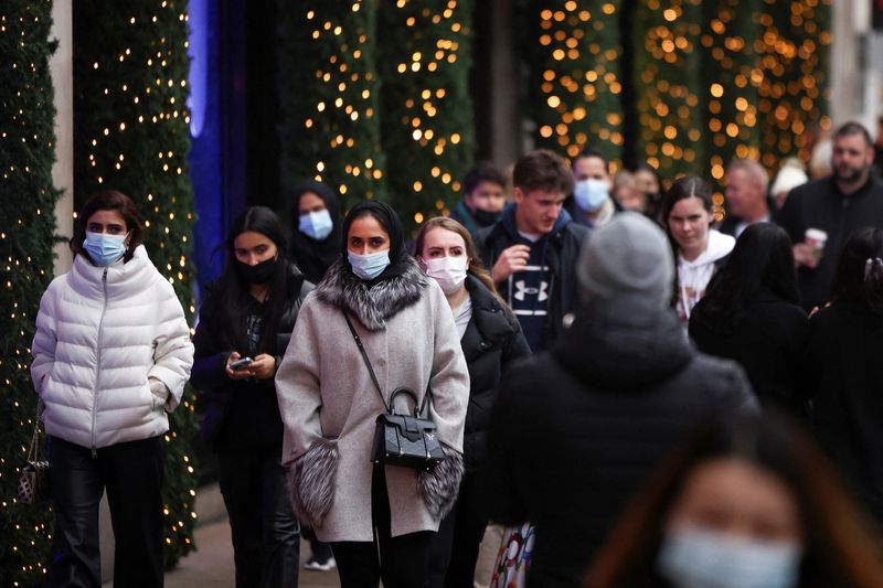 FILE PHOTO: Shoppers walk along Oxford Street, amid the coronavirus disease (COVID-19) outbreak in London