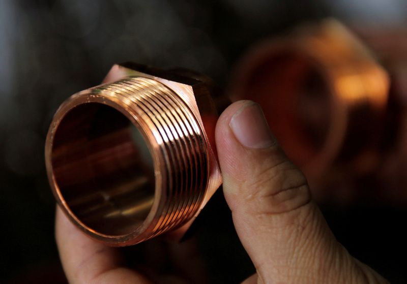 FILE PHOTO: A vendor shows copper components used for plumbing seen on sale at the Surtidora Ferretera River Store in Mexico City