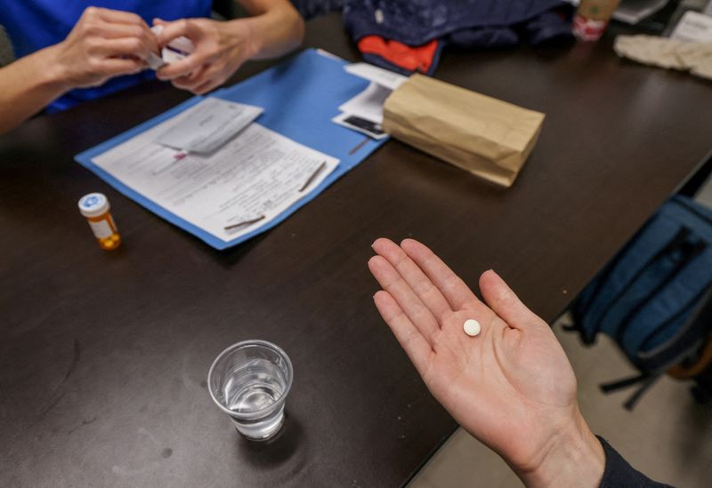 FILE PHOTO: FILE PHOTO: Dr. Shelly Tien hands a patient the initial abortion inducing medication at Trust Women clinic in Oklahoma City