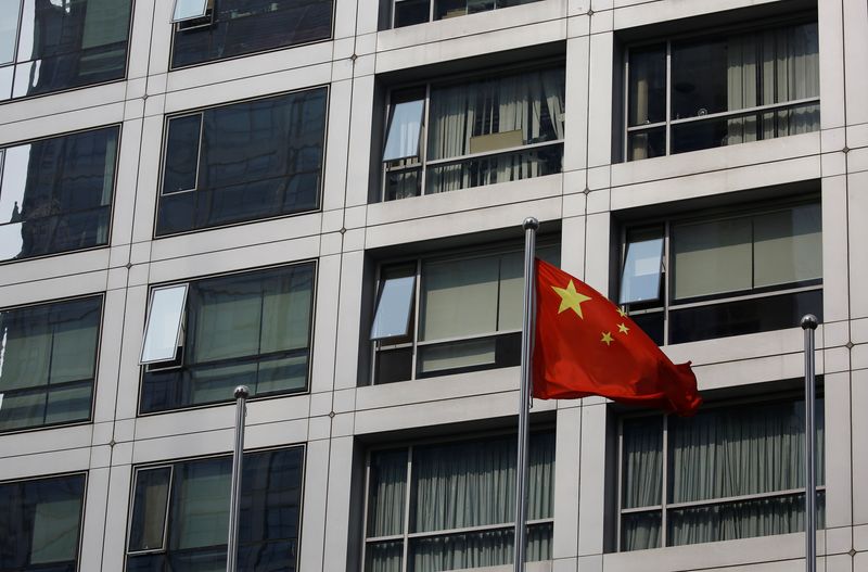 Chinese national flag flutters near the building of China Securities Regulatory Commission (CSRC) at the Financial Street area in Beijing