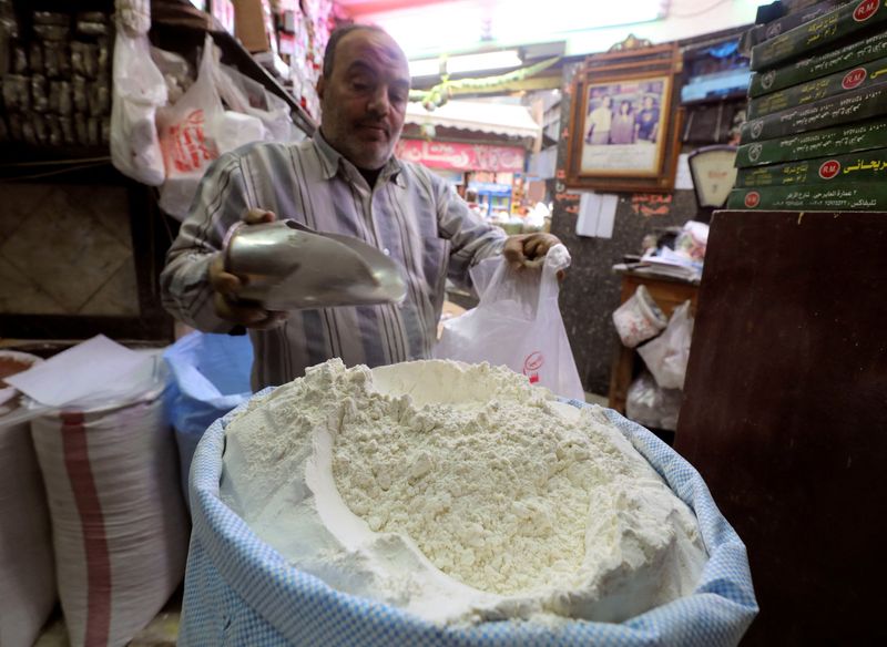 FILE PHOTO: A worker at a herbal store buys flour in Cairo