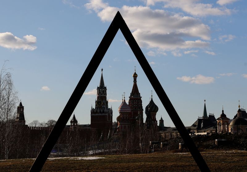 FILE PHOTO: The Kremlin's Spasskaya Tower and St. Basil's Cathedral are seen through the art object in Zaryadye park in Moscow
