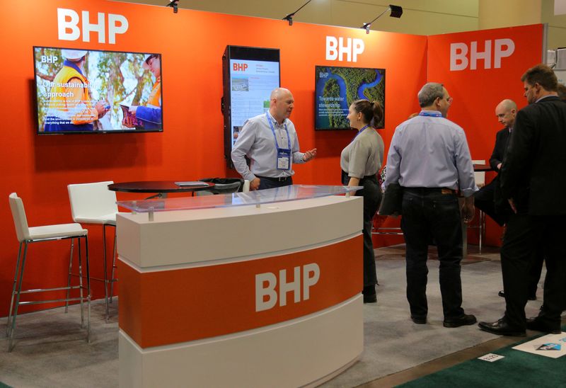 FILE PHOTO: Visitors to the BHP booth speak with representatives during the PDAC convention in Toronto