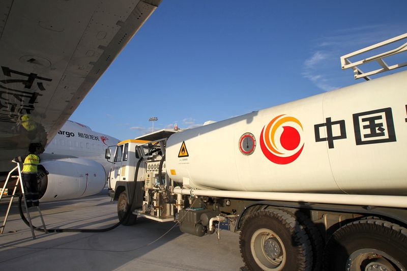 FILE PHOTO: Worker refuels a cargo aircraft with aviation fuel at an airport in Nantong