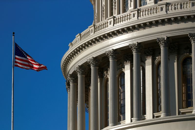 FILE PHOTO: A U.S. flag flies outside of the Capitol dome in Washington