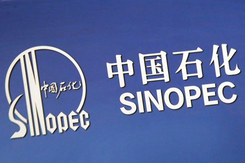 FILE PHOTO: The company logo of China’s Sinopec Corp is displayed at a news conference in Hong Kong