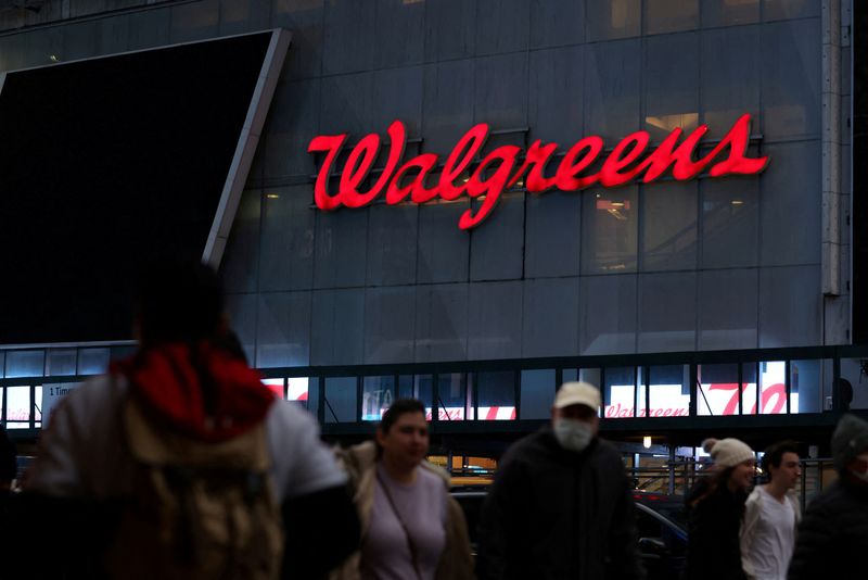 FILE PHOTO: People walk by a Walgreens, owned by the Walgreens Boots Alliance, Inc., in Manhattan, New York City