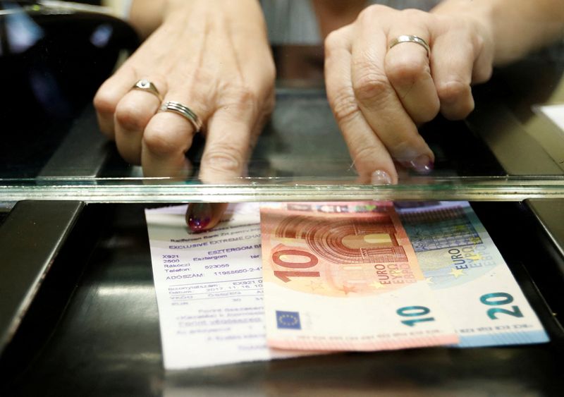 FILE PHOTO: Hungarian woman exchanges forints for euros at a currency exchange shop in Esztergom