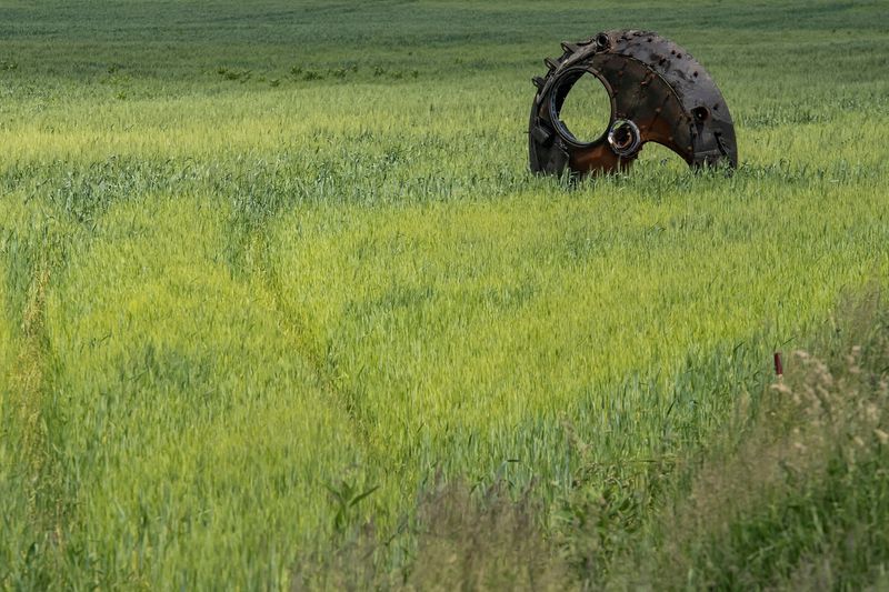 FILE PHOTO: A turret of a destroyed armoured fighting vehicle is seen in a field with wheat outside the town of Ichnia