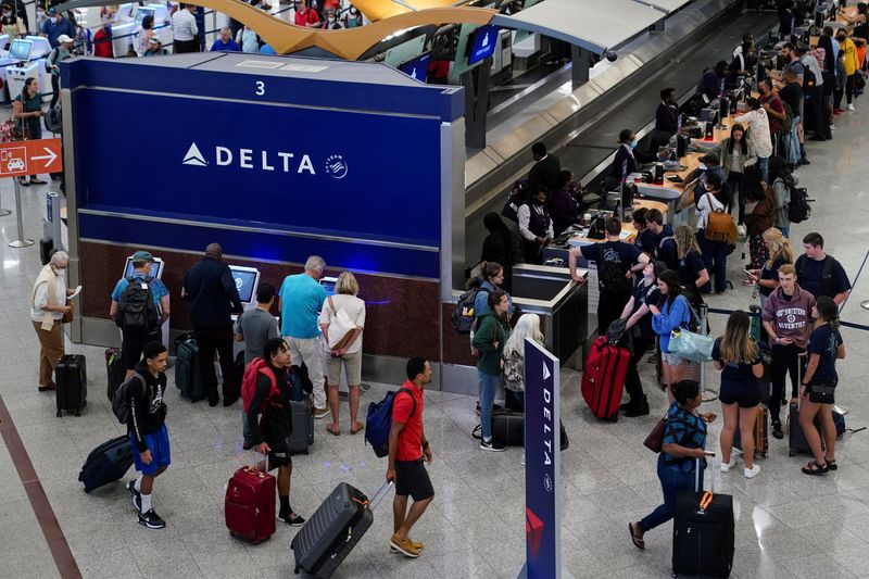 FILE PHOTO: Passengers line up before their flights at Hartsfield-Jackson Atlanta International Airport
