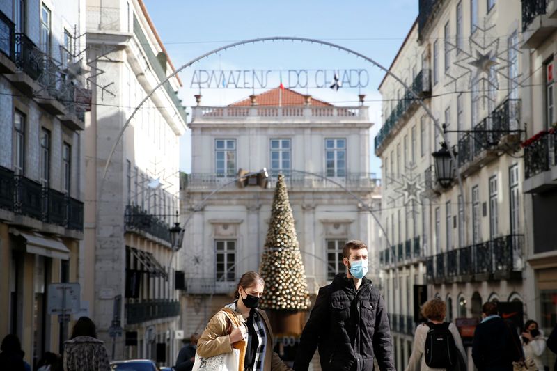 People are seen wearing protective masks during the coronavirus disease (COVID-19) pandemic in Lisbon
