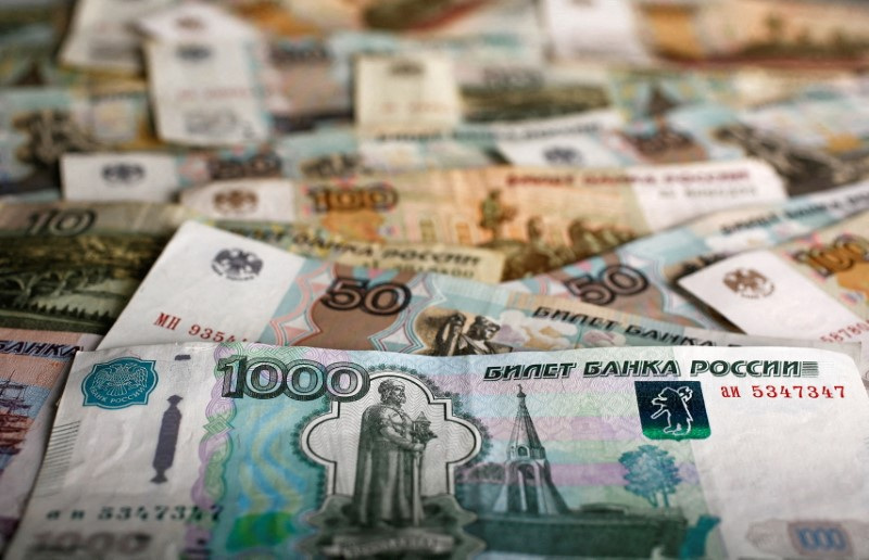 FILE PHOTO: A picture illustration shows Russian rouble banknotes of various denominations on a table in Warsaw