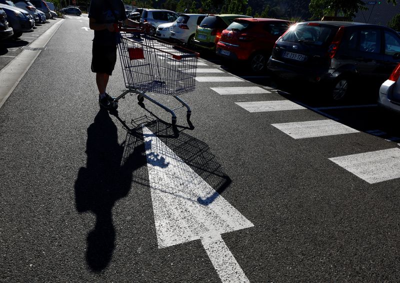 A man pushes a shopping cart in Nice