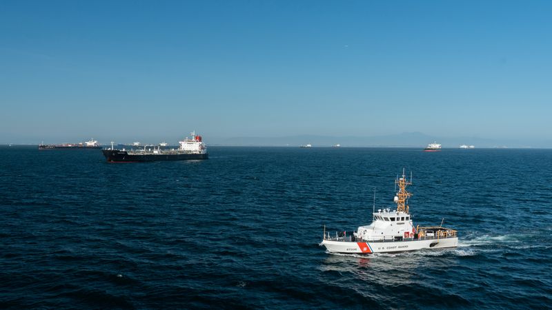FILE PHOTO: U.S. Coast Guard Cutter Narwhal patrols near some of the 27 oil tankers anchored off shore from Long Beach