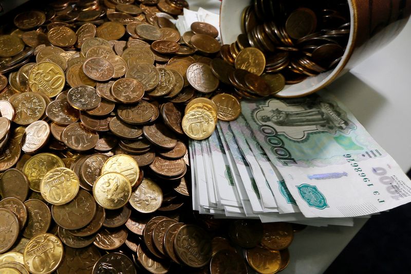 FILE PHOTO: Russian 1000-rouble banknotes, 50 and 10 kopeck coins are seen at a private company's office in Krasnoyarsk