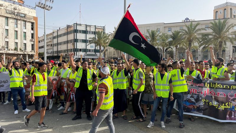 People protest against a power outage inside Martyrs' Square, in Tripoli