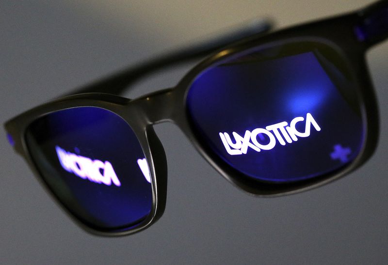FILE PHOTO: The Luxottica name is reflected in a pair of sunglasses  in this photo illustration taken in Rome