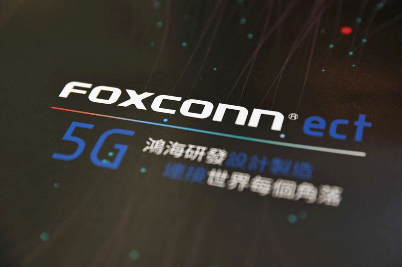 FILE PHOTO: A poster with a logo of Foxconn is seen at the IEEE Global Communications Conference in Taipei