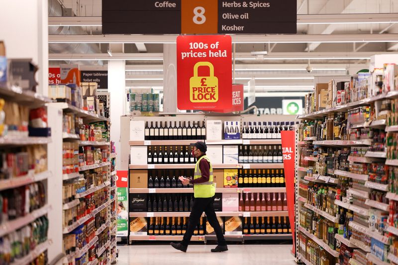 A employee walks inside a Sainsbury’s supermarket in Richmond, west London
