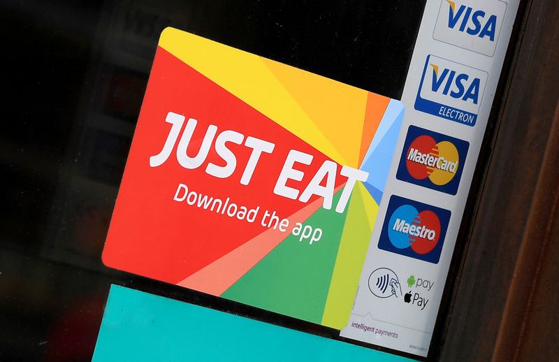 FILE PHOTO: Signage for Just Eat is seen on the window of a restaurant in London