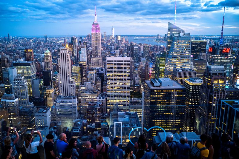 FILE PHOTO: People enjoy the Manhattan skyline during sunset in New York