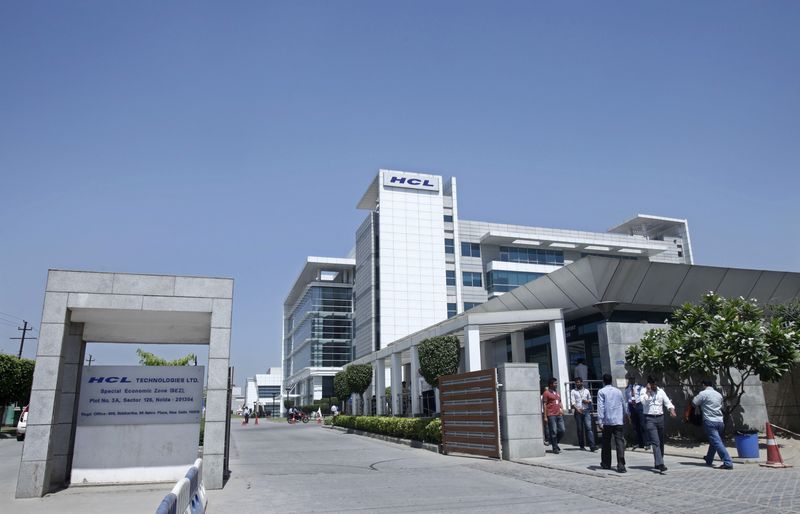 FILE PHOTO: People walk in front of the HCL Technologies Ltd office at Noida
