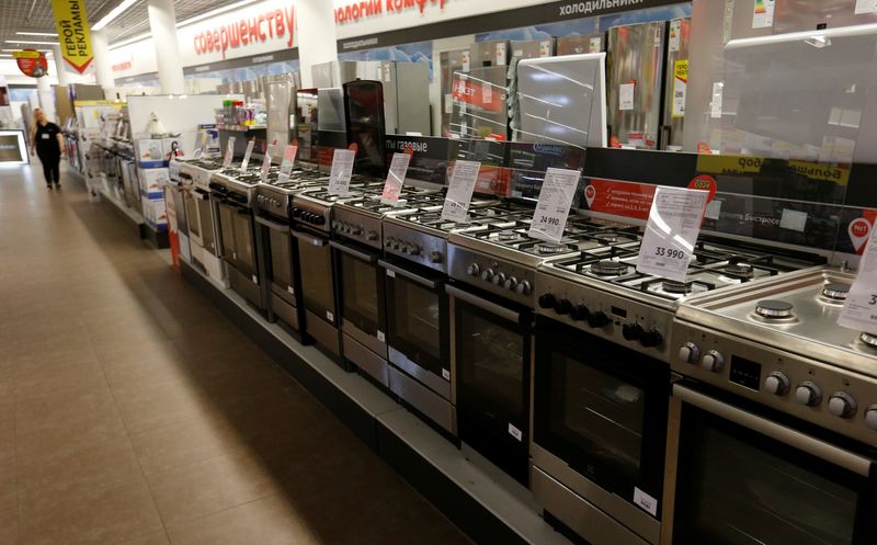 Employee walks past gas stoves on sale in store of Russia's biggest electrical and white goods retailer M.video in Moscow