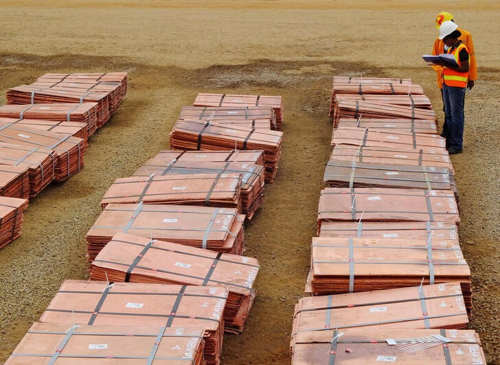 FILE PHOTO: Workers at Tenke Fungurume, a copper mine in Congolese province of Katanga, check bundles of copper cathode sheets