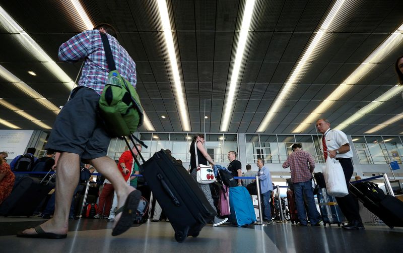 FILE PHOTO: Passengers make their way through a terminal at O'Hare International Airport in Chicago