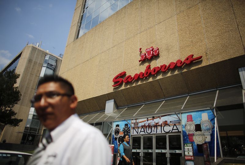 People walk outside a branch of retailer Sanborns in Mexico City