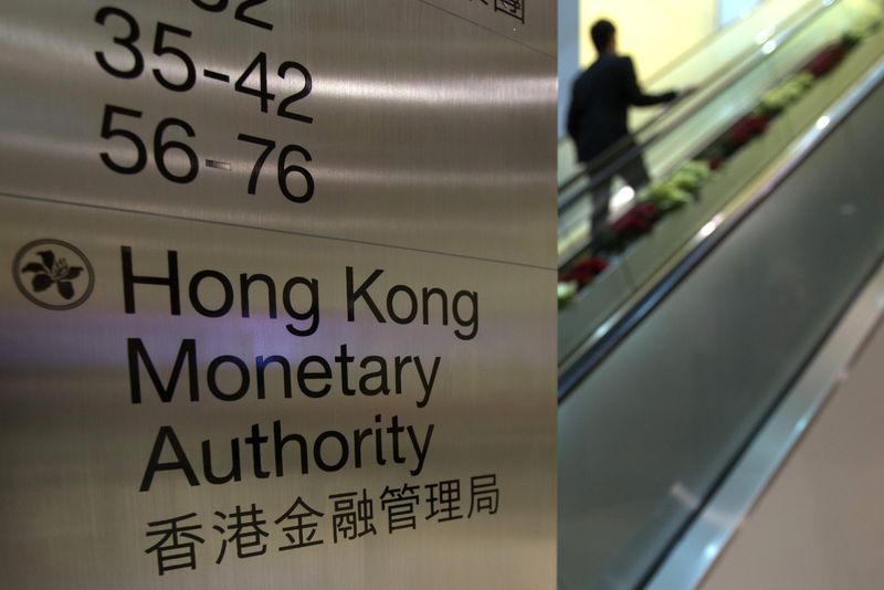 A security guard walks past a directory board of Hong Kong Monetary Authority (HKMA) in Hong Kong