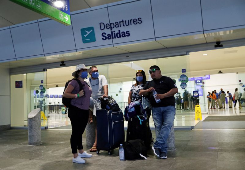 FILE PHOTO: Tourists wait to depart from Cancun's international airport