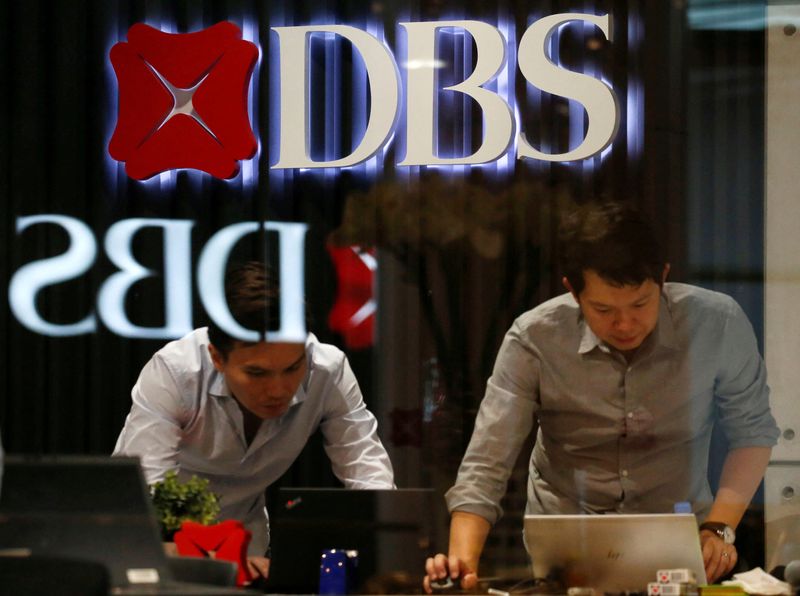 FILE PHOTO: DBS signages are seen as office workers work in Singapore