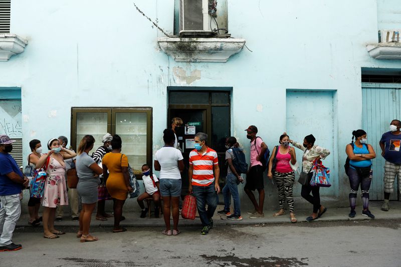 FILE PHOTO: People line up to buy food in downtown Havana