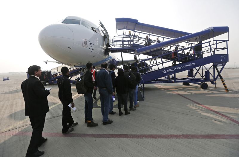 Passengers stand in a queue to board an Indigo Airlines' flight bound for New Delhi at the Srinagar airport