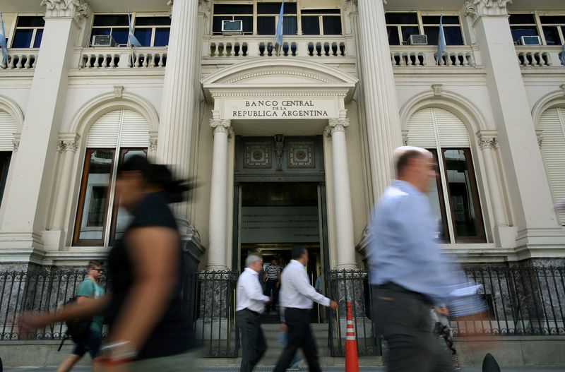 FILE PHOTO: Pedestrians pass by Argentina's Banco Central (Central Bank) in Buenos Aires' financial district