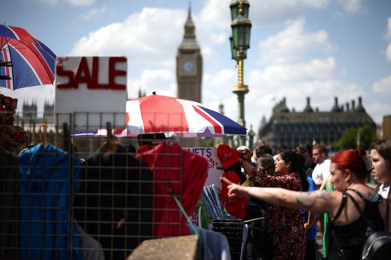 People browse items for sale at a souvenir shop on Westminster Bridge in London