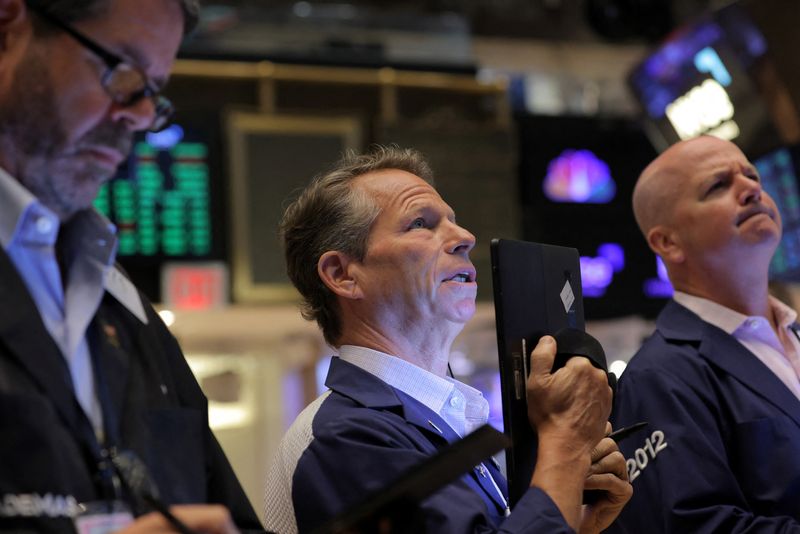 Traders work on the trading floor at the New York Stock Exchange (NYSE) in Manhattan, New York City
