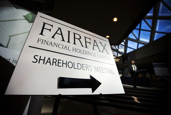 A man walks past a Fairfax Holdings sign directing shareholders to the meeting, at the annual general meeting for shareholders in Toronto
