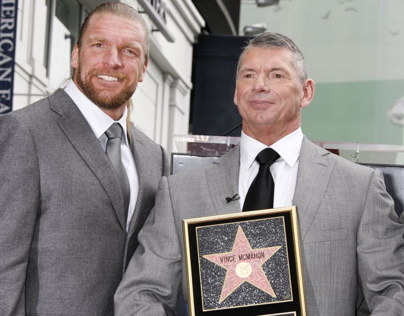 Vince McMahon and WWE star Triple H pose at the Hollywood Walk of Fame ceremony