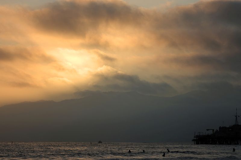 FILE PHOTO: The sun sets over the Pacific Ocean on the summer solstice in Santa Monica