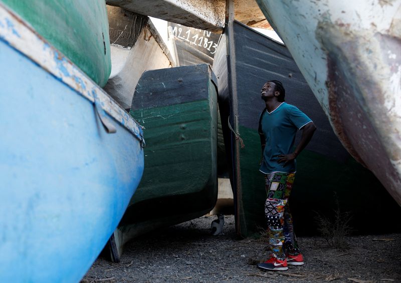  Mohamed Fane is seen in a cemetery of abandoned wooden boats in Arinaga