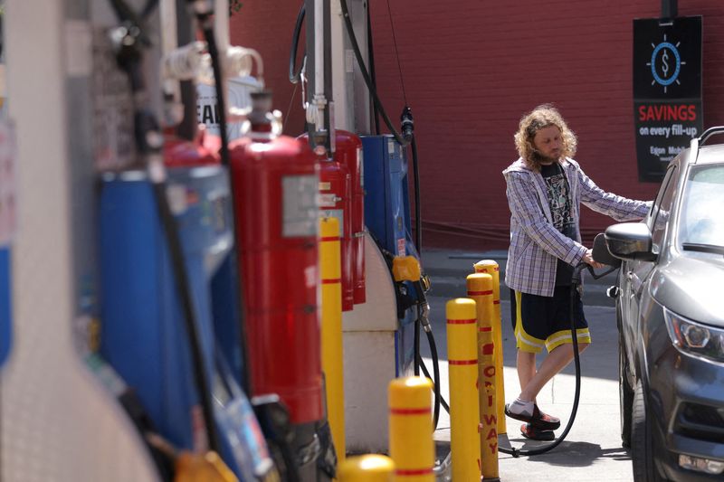 FILE PHOTO: A person puts gas in a vehicle at a gas station in Manhattan, New York City