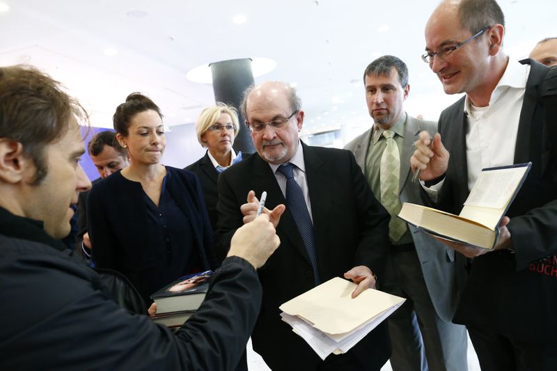 Author Rushdie signs autographs following opening news conference of the Frankfurt book fair