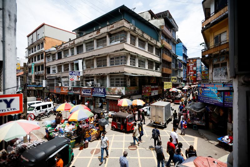 People walk along the Pettah Market, amid the country's economic crisis, in Colombo